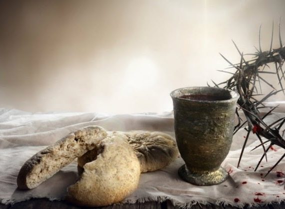 A communion display showing broken bread, a pottery goblet and a crown of thorns.